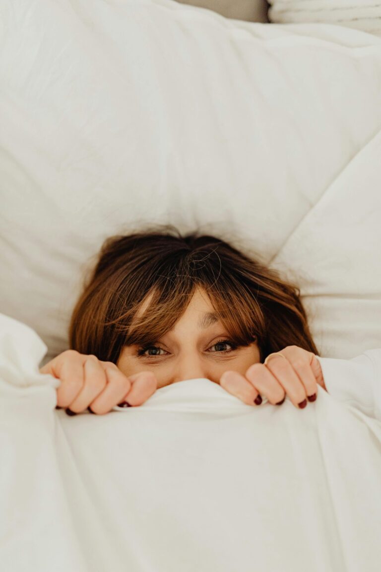 Woman peekin through covers