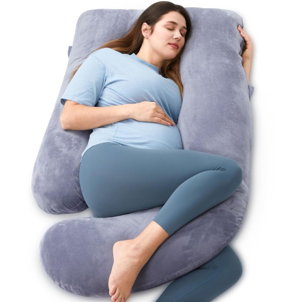 Pregnant woman lying on shaped full bodied pillow